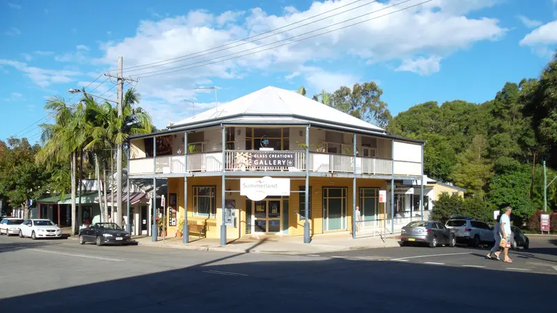Two-storey corner shopfront building with a verandah on Byron Street, Bangalow, New South Wales