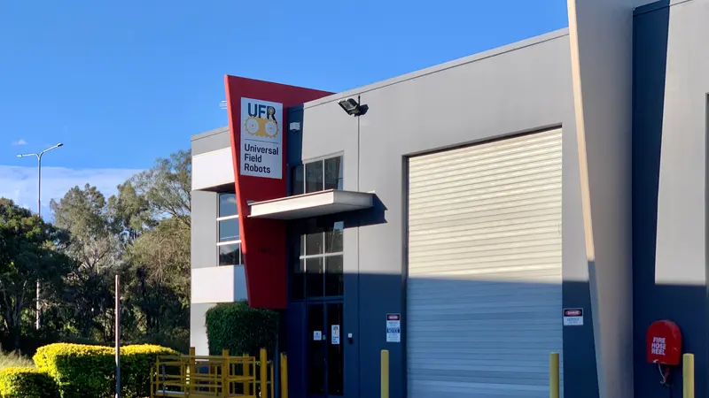 Modern industrial unit with a roller door and office frontage in Eagle Farm, Brisbane, under a clear blue sky