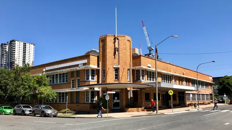 Two-storey brick commercial building at 62 Montague Road, South Brisbane, under a clear blue sky