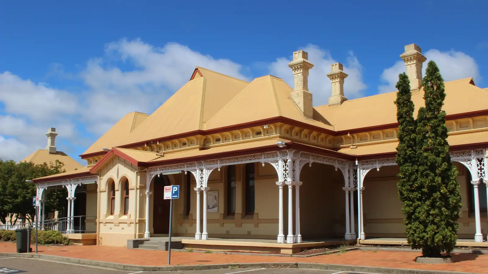 The heritage Armidale railway station building with its ornate verandah under a blue sky