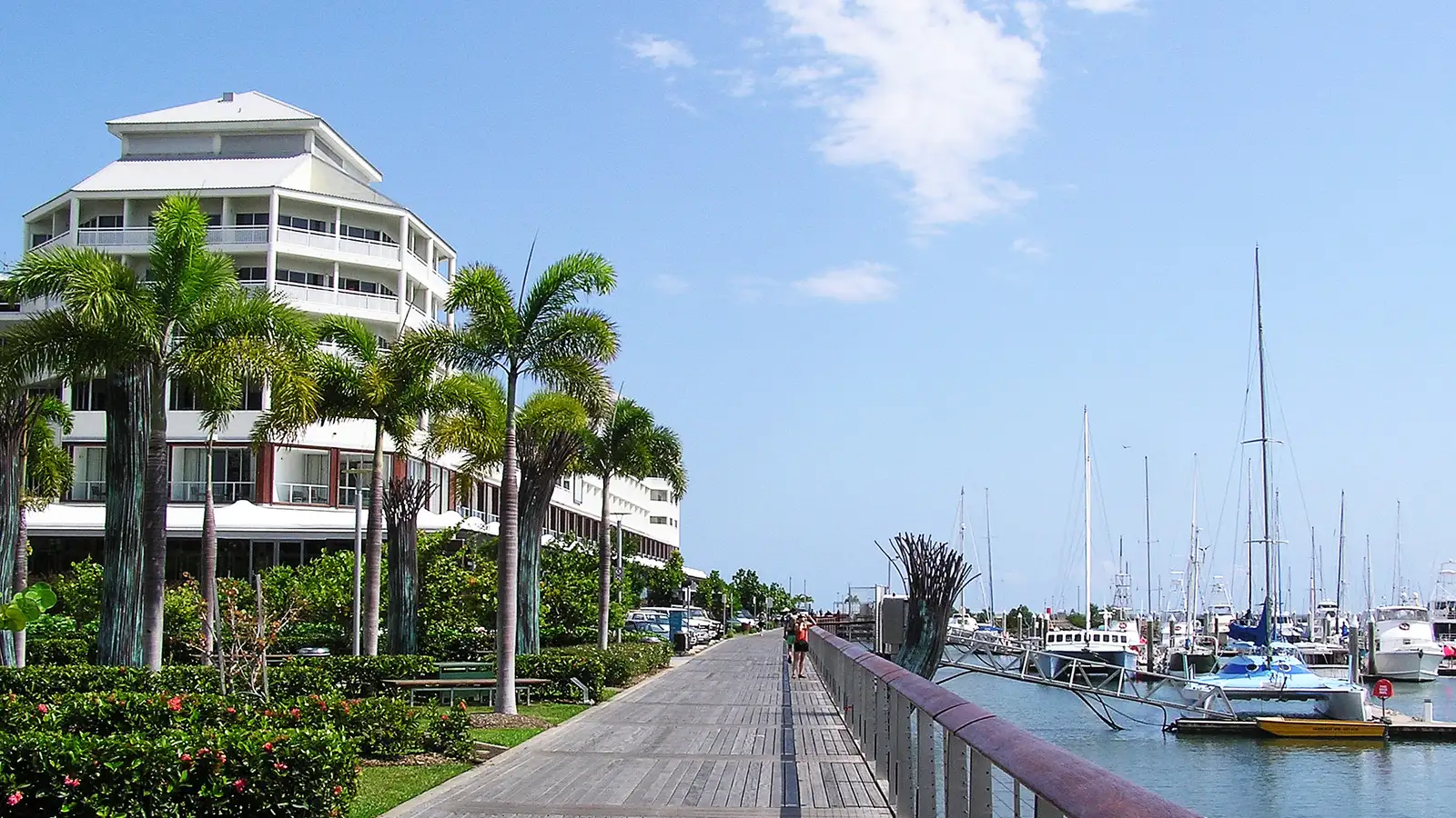 Cairns waterfront boardwalk beside the marina, with palm trees and yachts