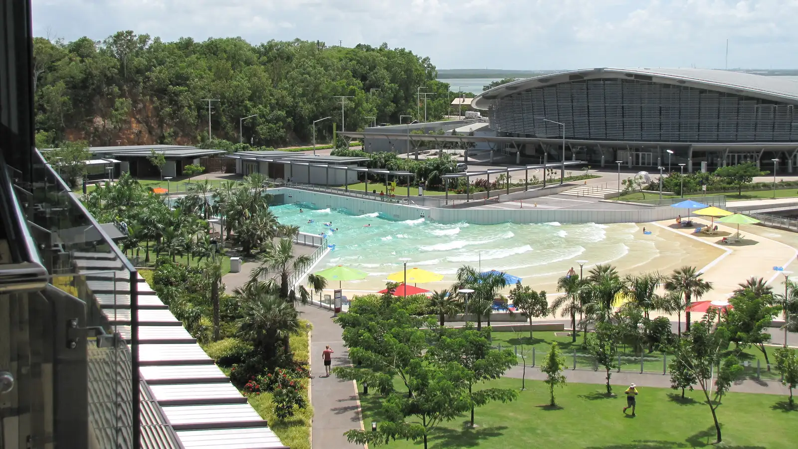 Darwin Waterfront precinct with the wave lagoon, palm trees and the convention centre