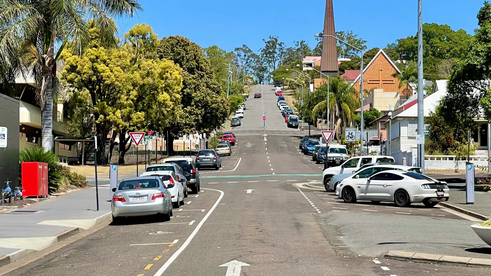 Nicholas Street in central Ipswich with palm trees and modern buildings under a blue sky
