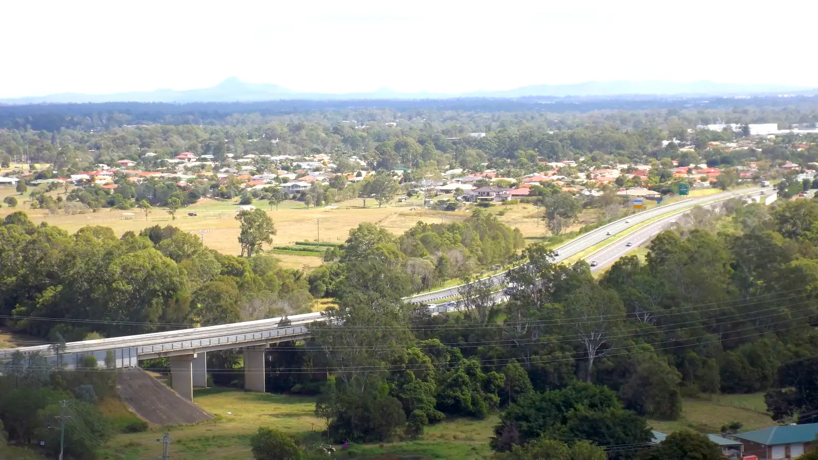 Logan Motorway bridge over Slacks Creek at Tanah Merah, with Meadowbrook homes and hills behind