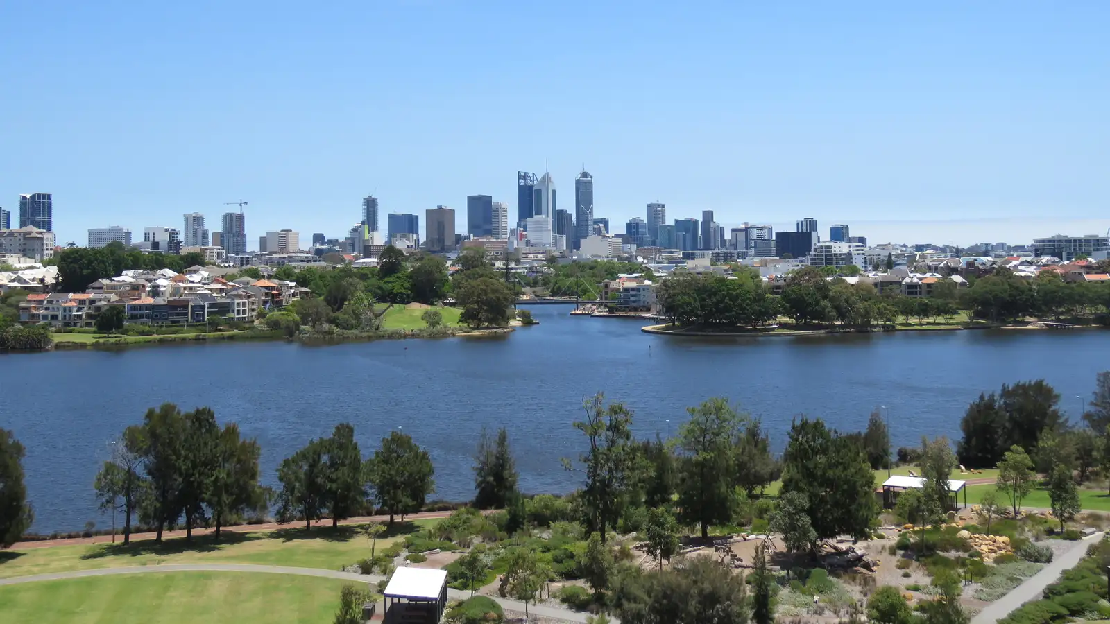 Perth city skyline across the Swan River from Perth Stadium, with East Perth homes in the foreground