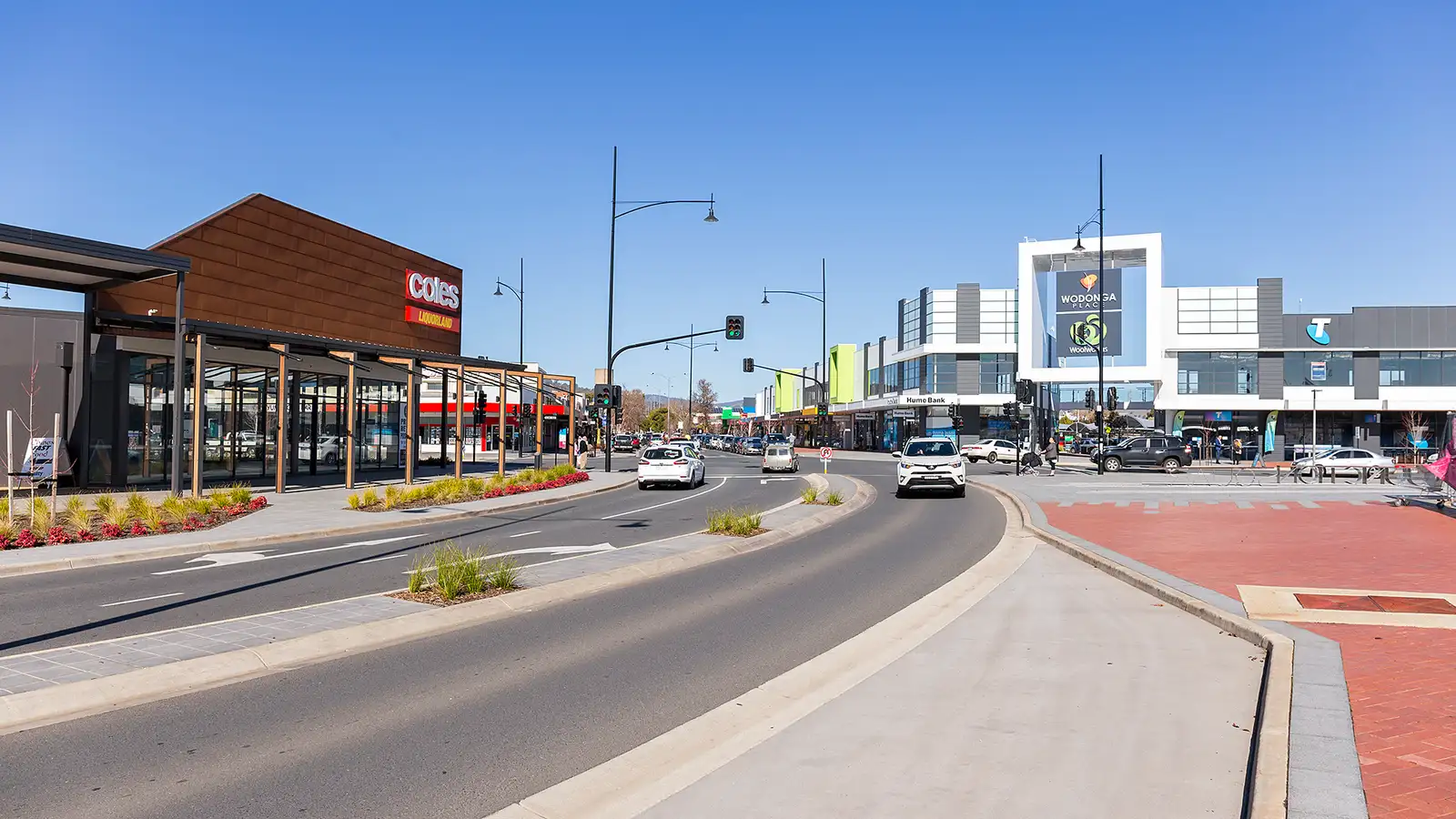 Wodonga High Street with new shopfronts and landscaped median on a sunny day